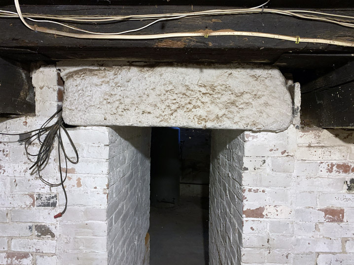 Brick piers and stone or wooden lintels  supporting fireplace