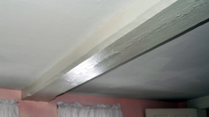 A chamfered summer beam with lambs tongue stop in the upstairs roof at 204 Dodge St. in Rowley